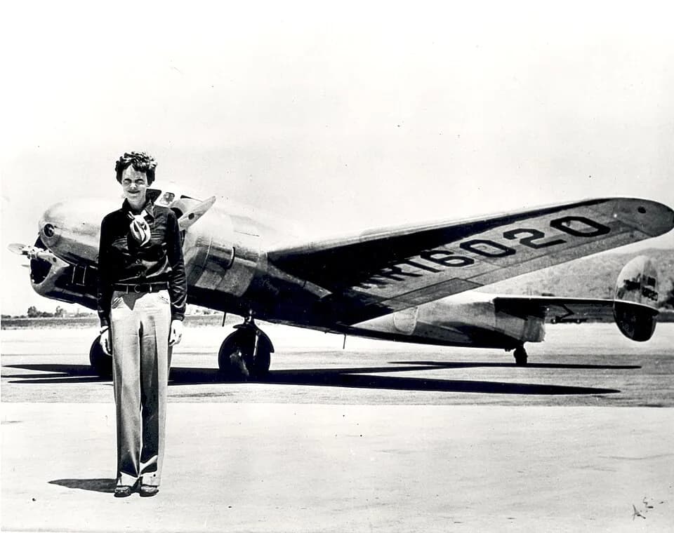 Amelia Earhart - Amelia Earhart standing in front of the Lockheed Electra in which she disappeared in July 1937. Born in Atchison, Kansas in 1897, Amelia Earhart did not begin flying until after her m