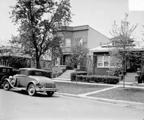 Al Capone - Home of Al Capone, a two-storied, bay-windowed building, with an undeveloped second lot, which is barricaded from vehicles by a line of trees that does not allow being climbed to access bu