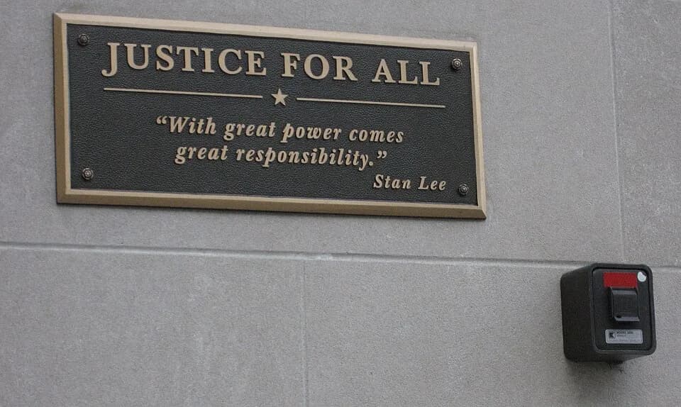 Stan Lee - Providence, Rhode Island. State Attorney General Building. Details by front door: curious quote on plaque; entrance security box.