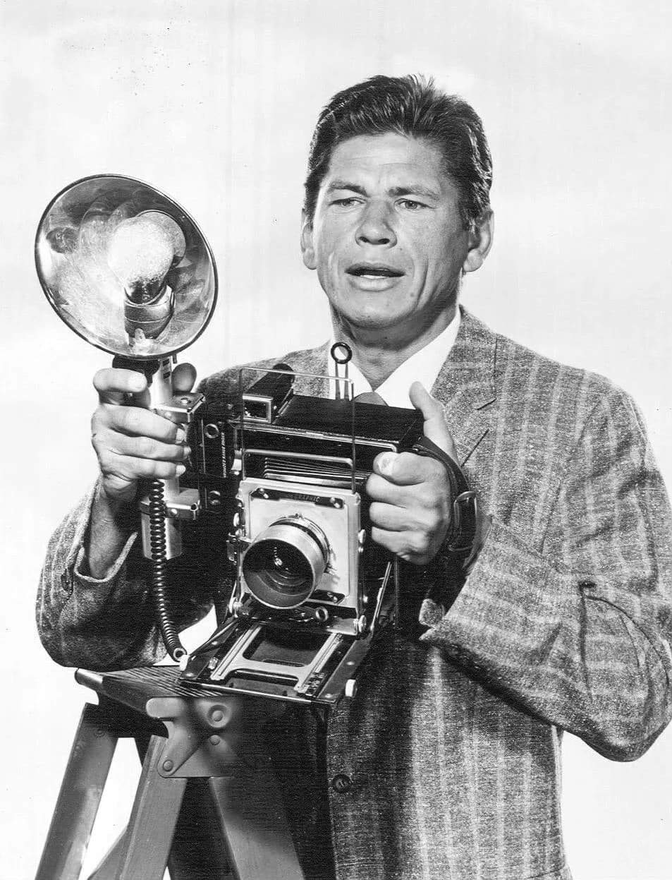 Charles Bronson - Photo of Charles Bronson as Mike Kovac from the television program Man With a Camera. (Probably a Speed Graphic camera.)