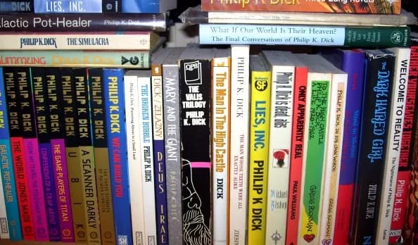 Philip K. Dick - shelf of books by and about Philip K. Dick, showing the spines only