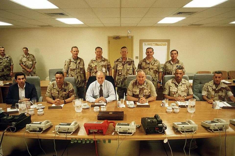 Colin Powell - Civilian and military officials pose for a group photograph prior to discussing U.S. military intervention in the Persian Gulf during Operation Desert Shield. Dignitaries include, from