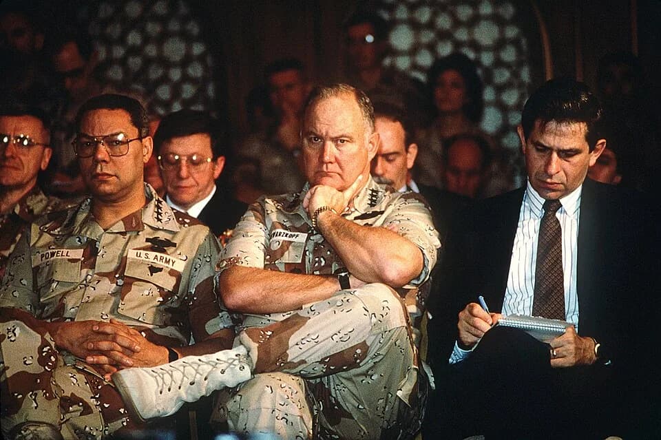 Colin Powell - Paul Wolfowitz, under secretary of defense for policy, right, takes notes while Gen. Colin Powell, chairman, Joint Chiefs of Staff, and Gen. Norman Schwarzkopf, Jr., commander-in-chief,