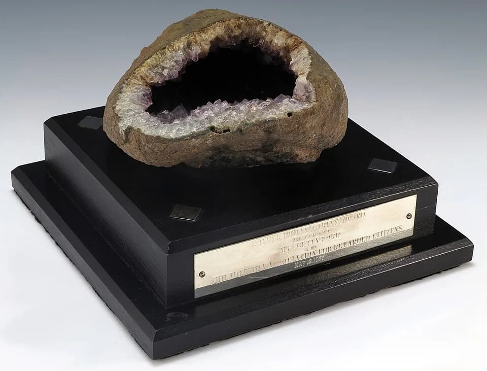 Betty Ford - Plaque featuring an amethyst rock set atop a black wooden base. The inscription reads, “Silver Humanitarian Award / Presented to / Betty Ford / By the / Philadelphia Association for Retar