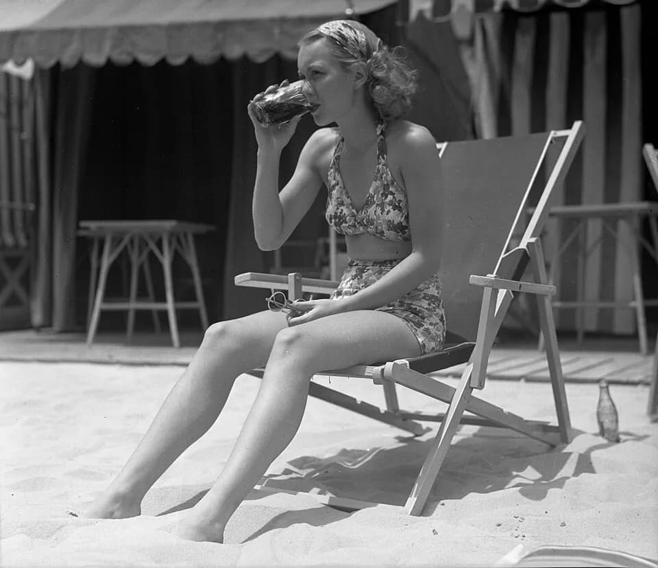 Jane Wyman - Title: Actress Jane Wyman sitting in lounge chair on California beach, 1935