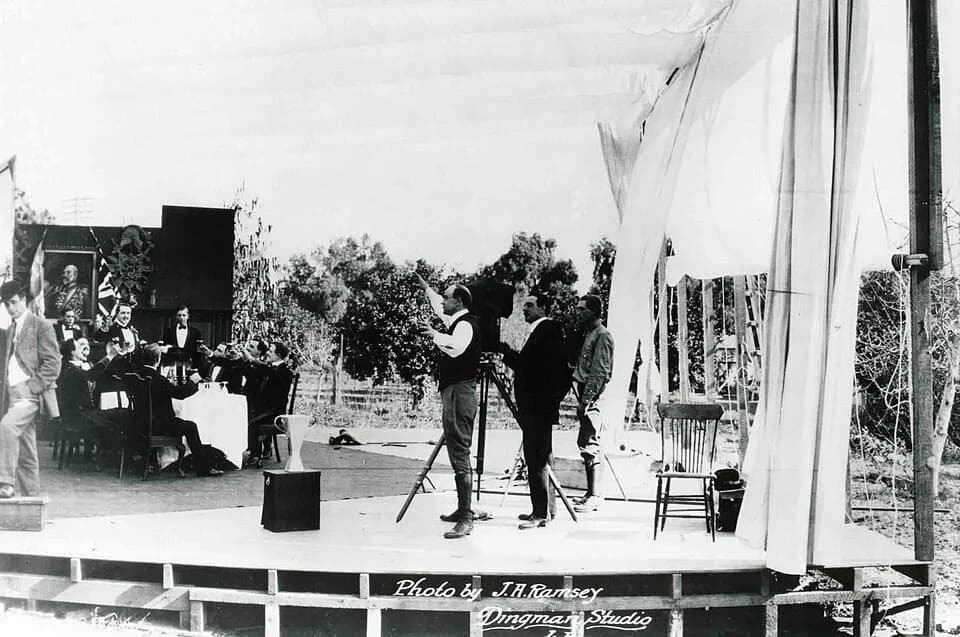 Cecil B. DeMille - First sequence shooting of the film The Squaw Man in 1913. Cecil B. DeMille, director of the film, is in the center of the picture, wearing boots and a light suit. Dustin Farnum, st