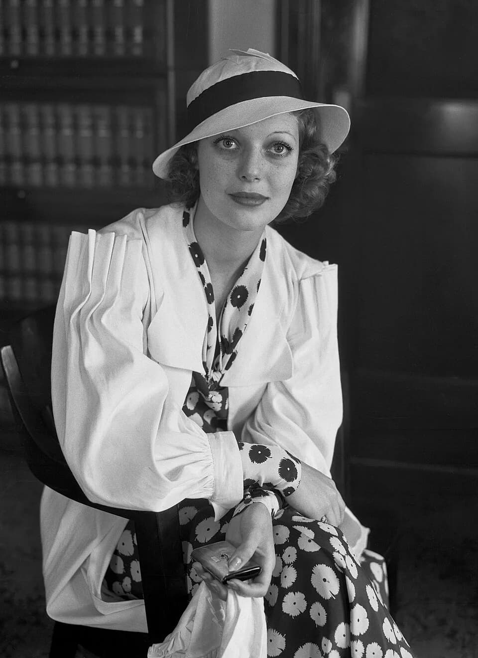 Loretta Young - Loretta Young sits in a chair in what appears to be an office.