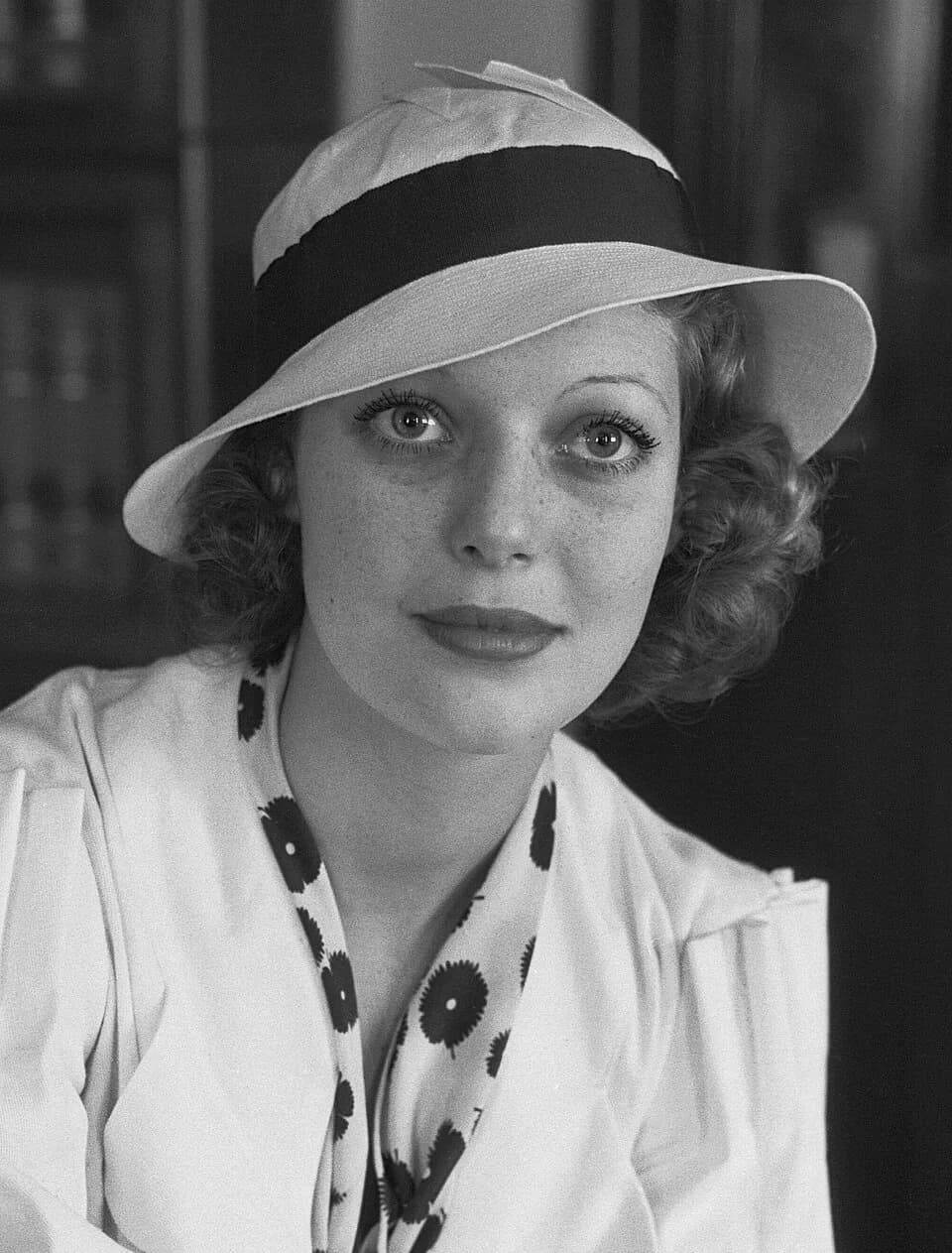 Loretta Young - Loretta Young sits in a chair in what appears to be an office.