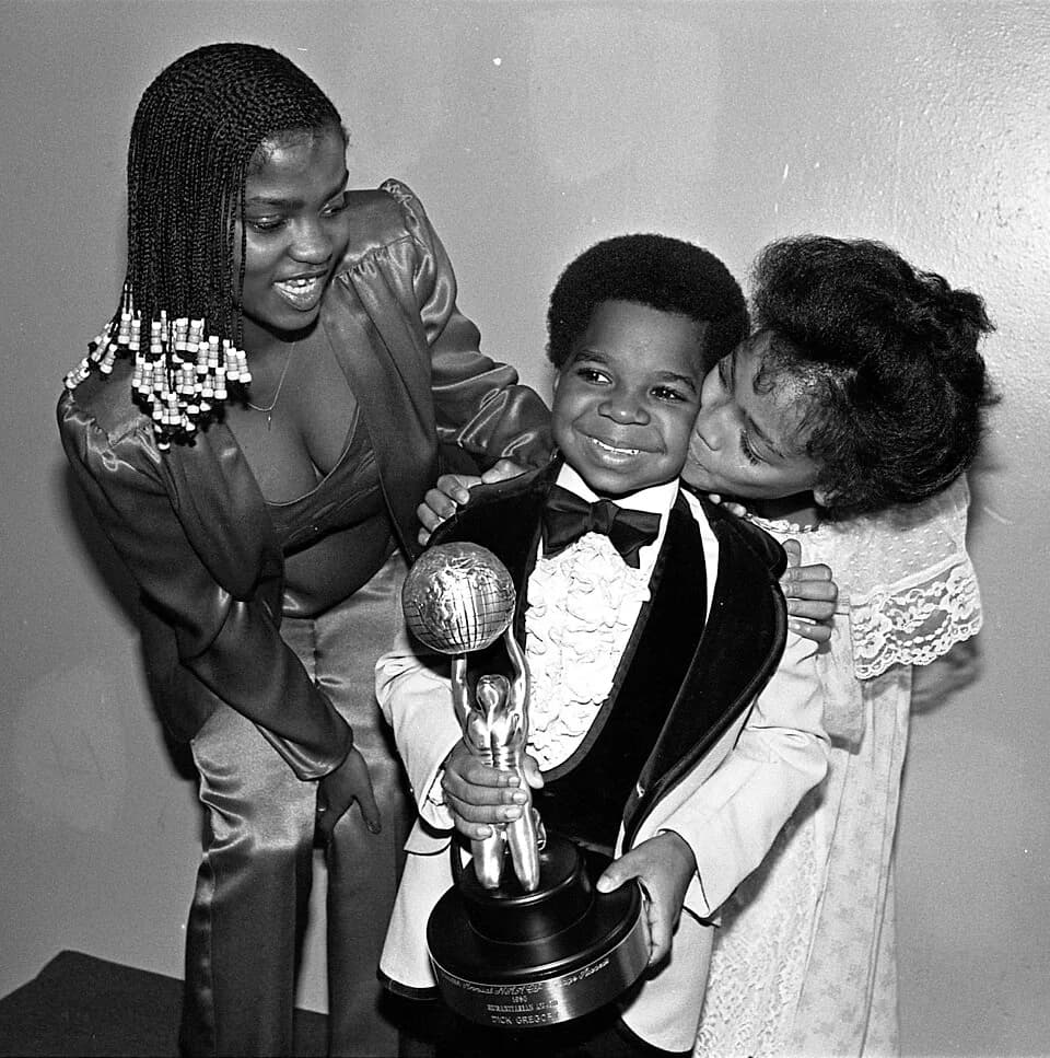 Gary Coleman - Gary Coleman clutches NAACP Image Award for the TV movie Kid From Left Field in which he starred. Looking on are Danielle Spencer, left, of What's Happening, and Kim Fields of The Facts