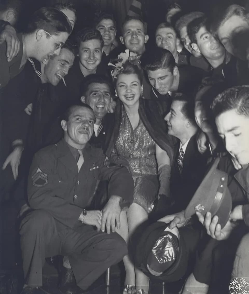 Anne Baxter - Anne Baxter in 1943 pose with United States Army soldiers
Photograph by the U.S. Army Signal Corps