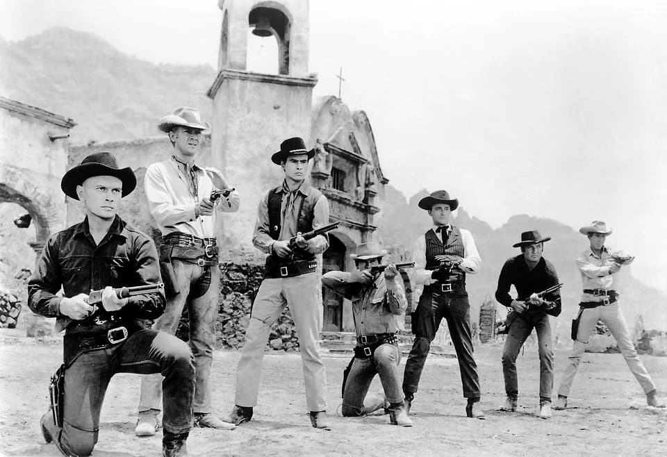 James Coburn - Publicity photo of the cast of 1960 western The Magnificent Seven. From left to right: Yul Brynner, Steve McQueen, Horst Buchholz, Charles Bronson, Robert Vaughn, Brad Dexter, and James