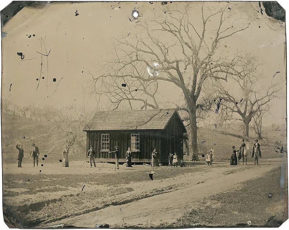 Billy the Kid - 4×5 inch tintype which depicts Billy the Kid, and several members of his gang, The Regulators, playing a leisurely game of croquet alongside friends, family, and lovers in the late sum