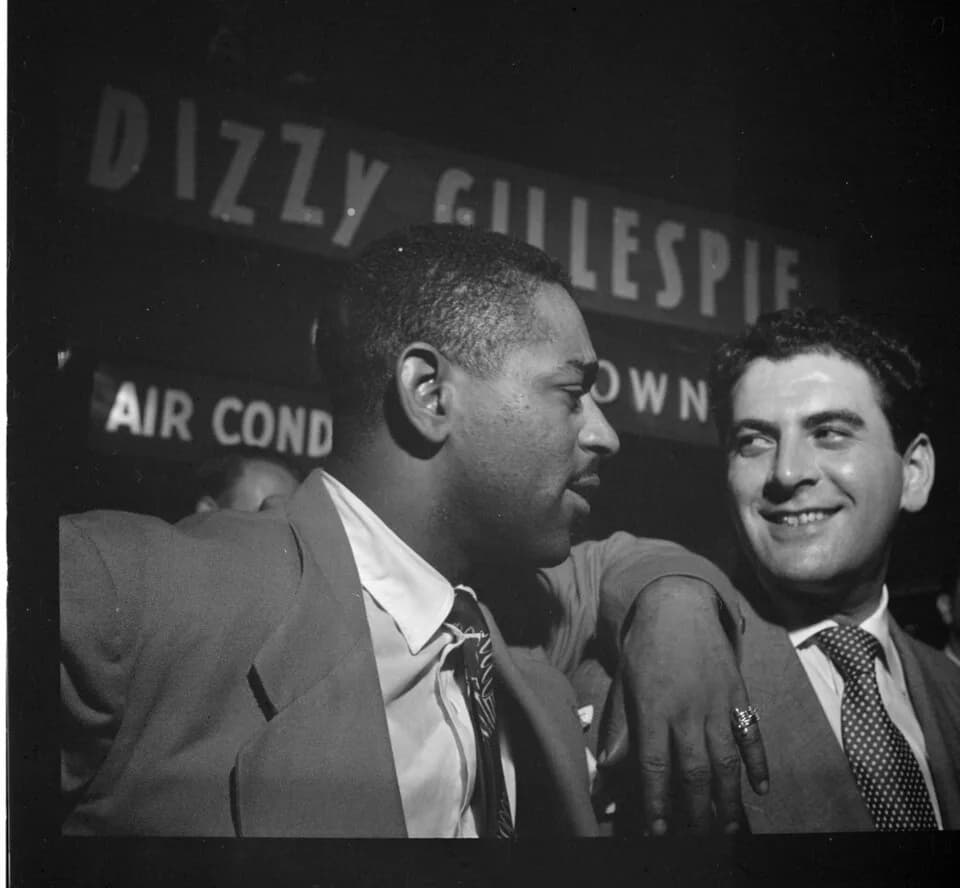 Dizzy Gillespie - Gottlieb, William P., 1917-, photographer.
[Portrait of Dizzy Gillespie and Georgie Auld, Downbeat, New York, N.Y., ca. Aug. 1947]
1 negative :  b&amp;w ; 2 1/4 x 2 1/4 in.
Notes:
 G