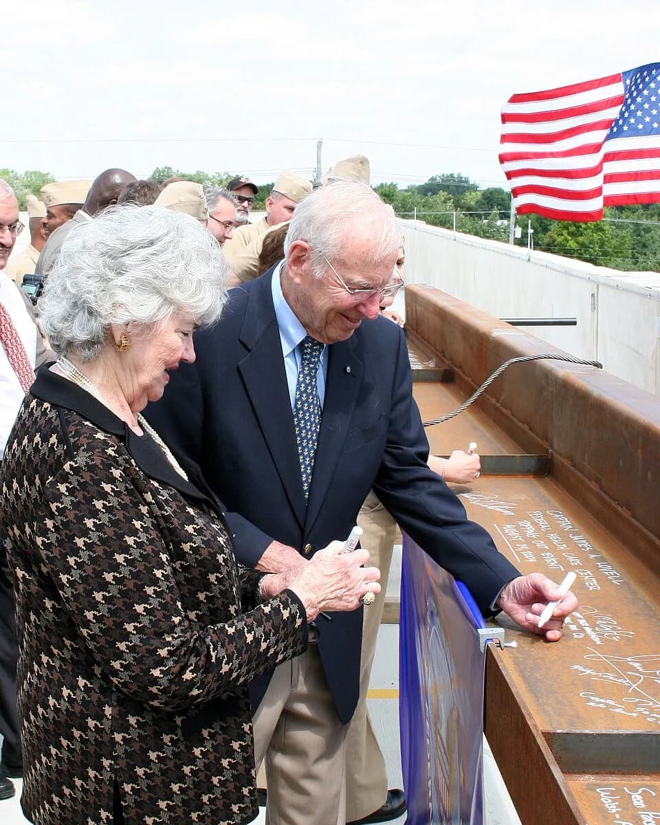 Jim Lovell - GREAT LAKES, Ill. (Aug. 24, 2009) Retired Navy captain and former astronaut Jim Lovell and his wife, Marilyn Gerlach, sign the final roofing beam to be lifted into place during the toppin