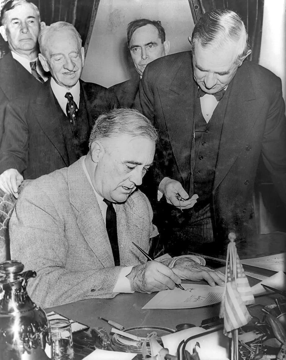 Alben W. Barkley - United States President Franklin D. Roosevelt signing the declaration of war against Germany, marking US entry into World War II in Europe. Senator Tom Connally stands by holding a 