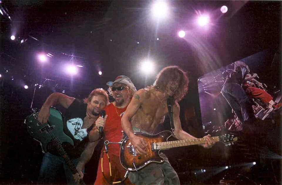 Eddie Van Halen - Michael Anthony, Sammy Hagar, and Eddie Van Halen on stage.