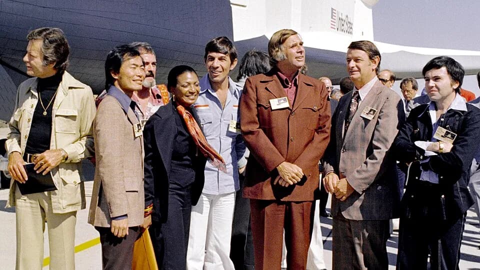 Gene Roddenberry - The Space Shuttle Enterprise rolls out of the Palmdale manufacturing facilities with Star Trek television cast and crew members. From left to right: DeForest Kelley, (Dr McCoy); Geo