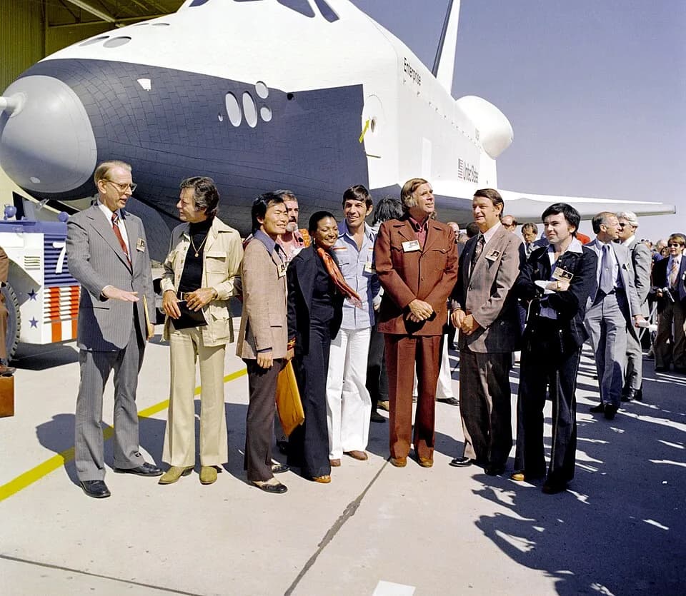 Gene Roddenberry - (September 17, 1976) The Shuttle Enterprise rolls out of the Palmdale manufacturing facilities with Star Trek television cast members. From left to right they are: Dr. James D. Flet