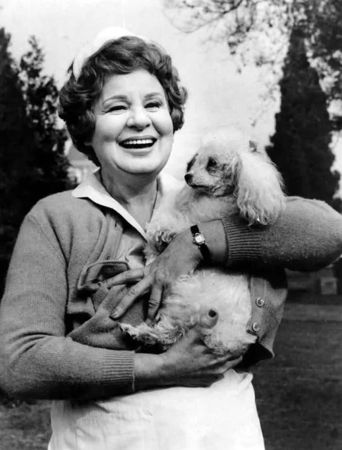Shirley Booth - Shirley Booth with her dog Prego between takes on the set of the television program Hazel.