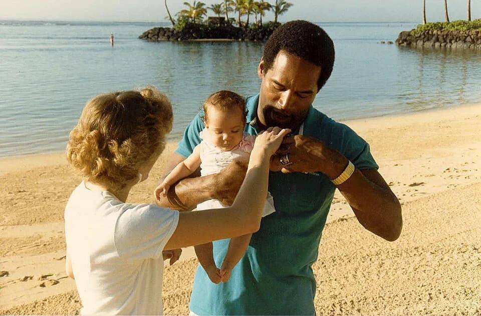 O. J. Simpson - Photo taken February 1986 at the Kahala Hilton Hotel in Honolulu Hawaii - This is my sister Jan, who asked for a photo with O.J. - O.J. is holding his daughter Sydney.  
Nicole Brown S