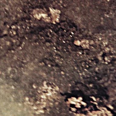 William Lipscomb - Lipscombite: Mineral.  Small black crystals on dark background.  Smithsonian National Museum of Natural History, Washington DC, mineral collection.  Sample was in the large mineral 