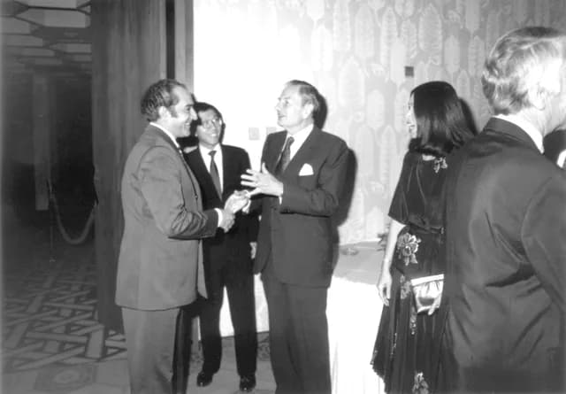 David Rockefeller - Year 1980. During his visit to Abu Dhabi, David Rockefeller (right) is seen shaking hands with Jawad Hashim (left) who was the President of the Arab Monetary Fund at that time. Sub