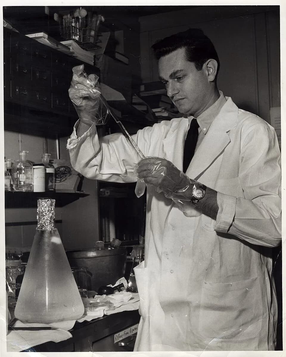 Marshall Warren Nirenberg - Marshall_Nirenberg_performing_experiment. Photograph of experiment likely related to protein synthesis and genetic code translation.