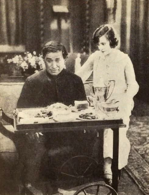 Will Rogers - Still from the American film A Poor Relation (1921) with Will Rogers and Sylvia Breamer, on page 36 of the November 1921 Photoplay.
