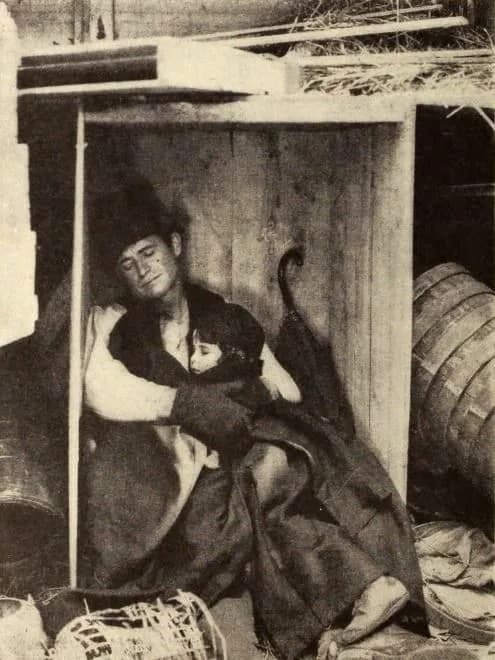 Will Rogers - Still from the American film A Poor Relation (1921) with Will Rogers and child actors Robert DeVilbiss and Jeanette Trebaol, on page 35 of the November 1921 Photoplay.
