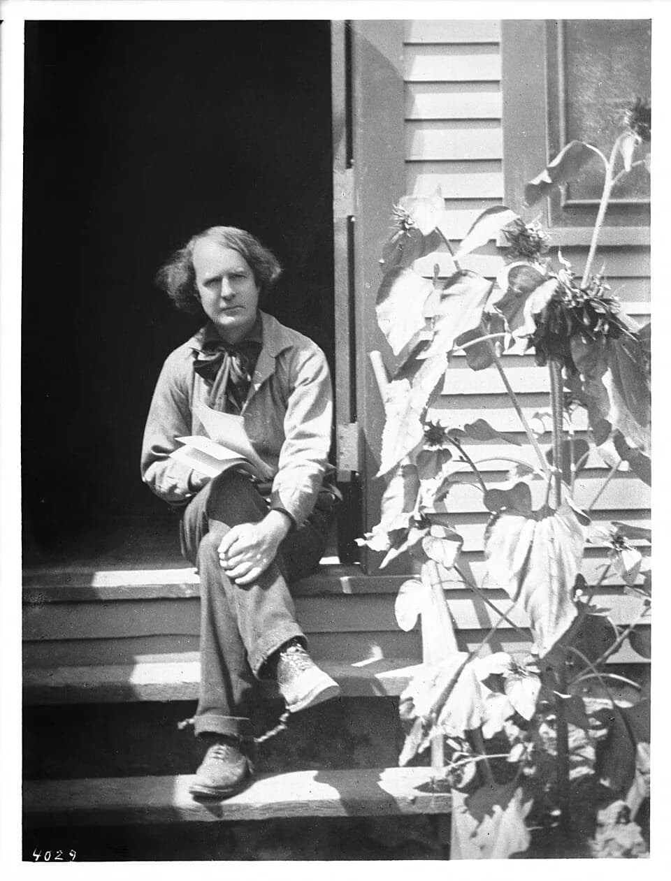 Elbert Green Hubbard - Portrait of Elbert Hubbard outside his workshop, ca.1900
Photographic portrait of Elbert Hubbard outside his workshop, ca.1900. He is sitting on the threshhold of the front door