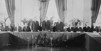 Frank B. Kellogg - Calvin Coolidge, Herbert Hoover, and Frank B. Kellogg, standing, with representatives of the governments who have ratified the Treaty for Renunciation of War (Kellogg-Briand Pact), 