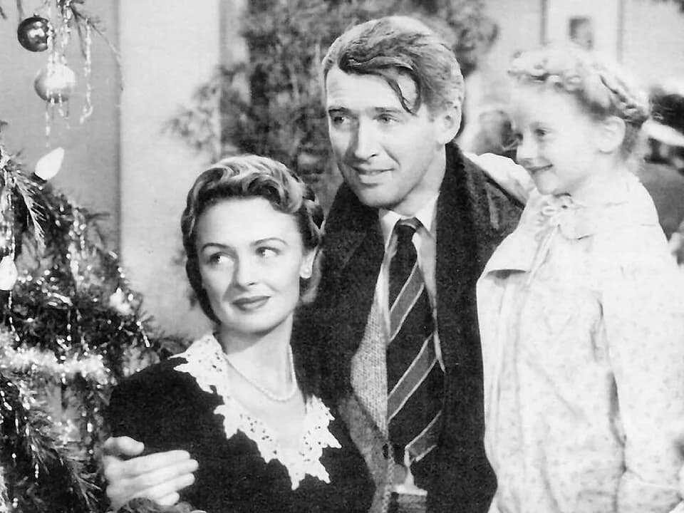 Donna Reed - Screenshot of Jimmy Stewart, Donna Reed, and Karolyn Grimes in the American film It's a Wonderful Life (1946).  The film lapsed into the public domain in the United States due to the fail