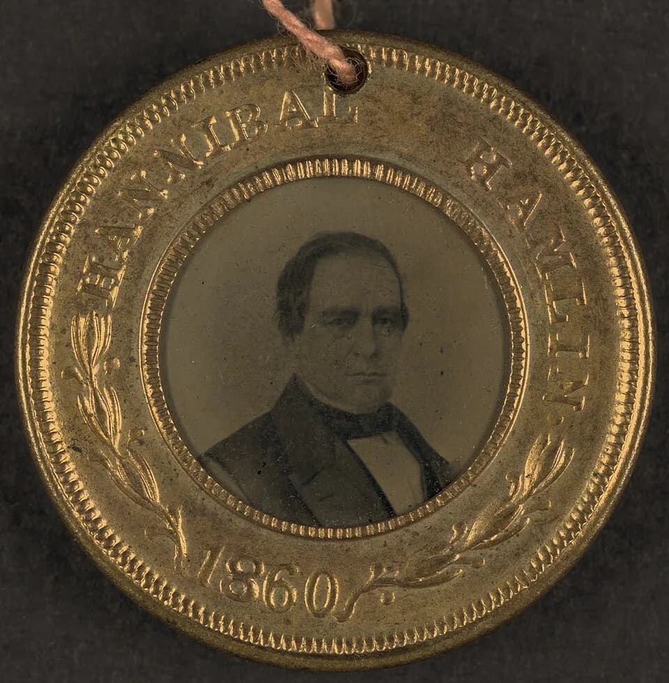 Hannibal Hamlin - Campaign button for Hannibal Hamlin, 1860.  Portrait appears in tintype.  Hannibal Hamlin was vice presidential running mate to Abraham Lincoln, whose portrait appears on the other s