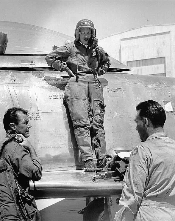 Chuck Yeager - Jacqueline Cochran standing on the wing of her Canadair Sabre Mk.3 whilst talking to Chuck Yeager and Canadair's chief test pilot Bill Longhurst.