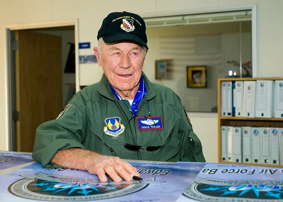 Chuck Yeager - Retired Brig. Gen. Chuck Yeager pauses for a moment while autographing several Edwards Air Force Ball posters at Test Operations here Sept. 21. General Yeager flew an F-16 to Mach 1 at 