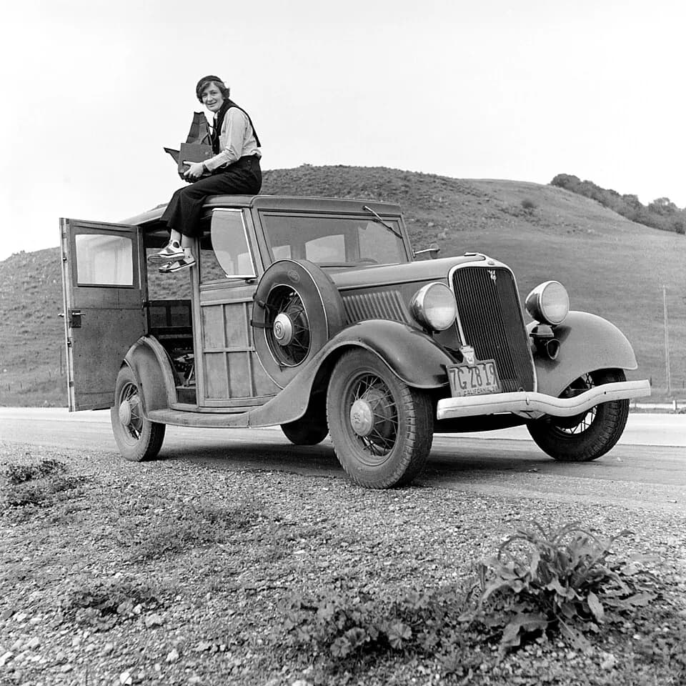 Dorothea Lange - Dorothea Lange, Resettlement Administration photographer, in California. The car is a w:Ford Model V8 (more exactly, this one is Model 40). The camera is a Graflex 4x5 Series D.