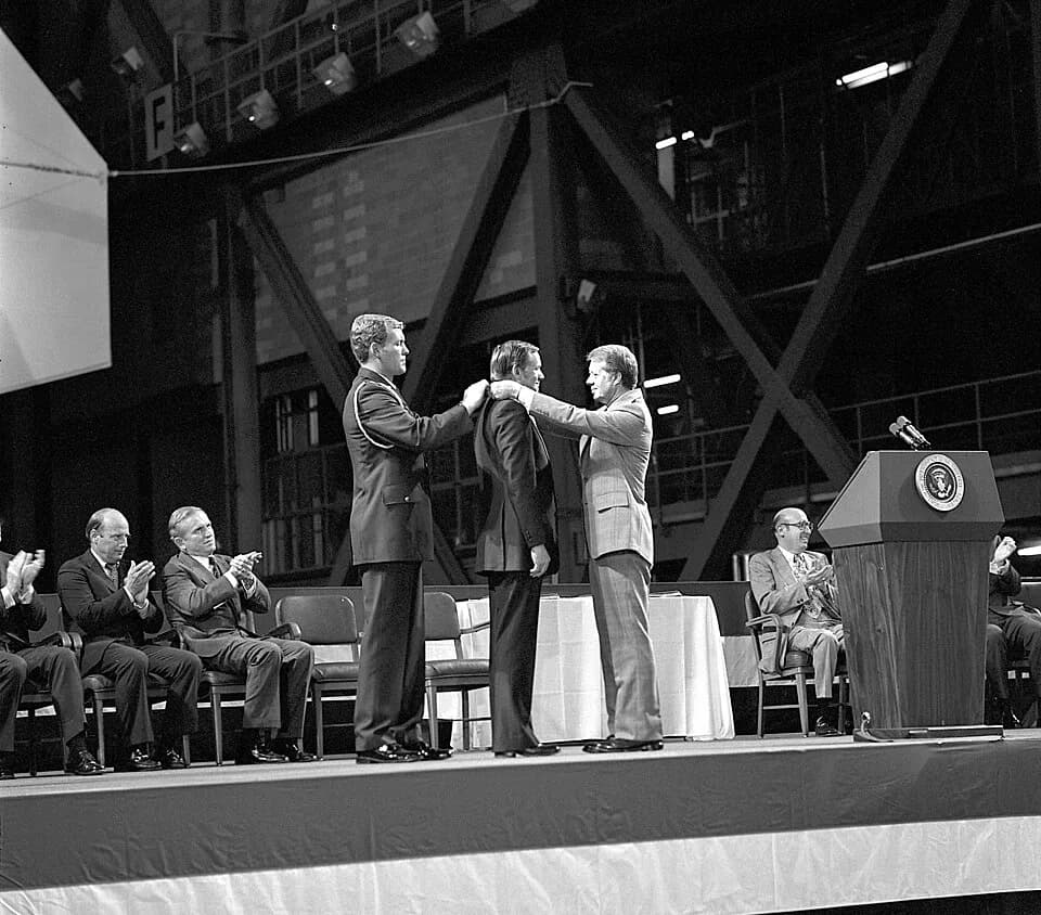 Pete Conrad - Astronaut Neil A. Armstrong receives the first Congressional Space Medal of Honor from United States President Jimmy Carter, assisted by Captain Robert Peterson. Astronauts Pete Conrad (