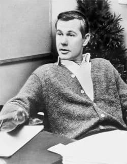 Johnny Carson - Johnny Carson talks about TV commercials.  Johnny Carson, half-length portrait, seated behind desk.
