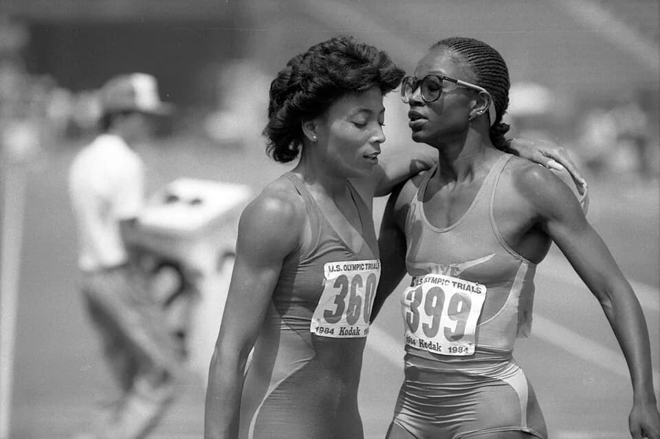 Florence Griffith Joyner - Florence Griffith (left) of Los Angeles congratulates Valerie Brisco-Hooks on her first place finish in heat one of second round of qualifying in women's 400 meters at  the1