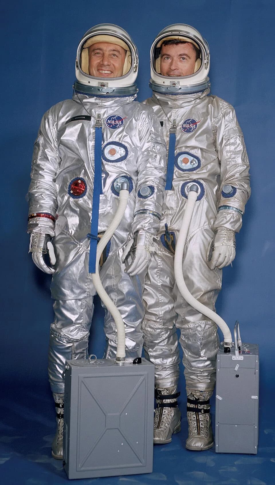 John Young - "Gemini III crew members Virgil I. "Gus" Grissom (left) and John W. Young are wearing their spacesuits, helmets and portable air conditioners." Note: These suits were not used on the miss