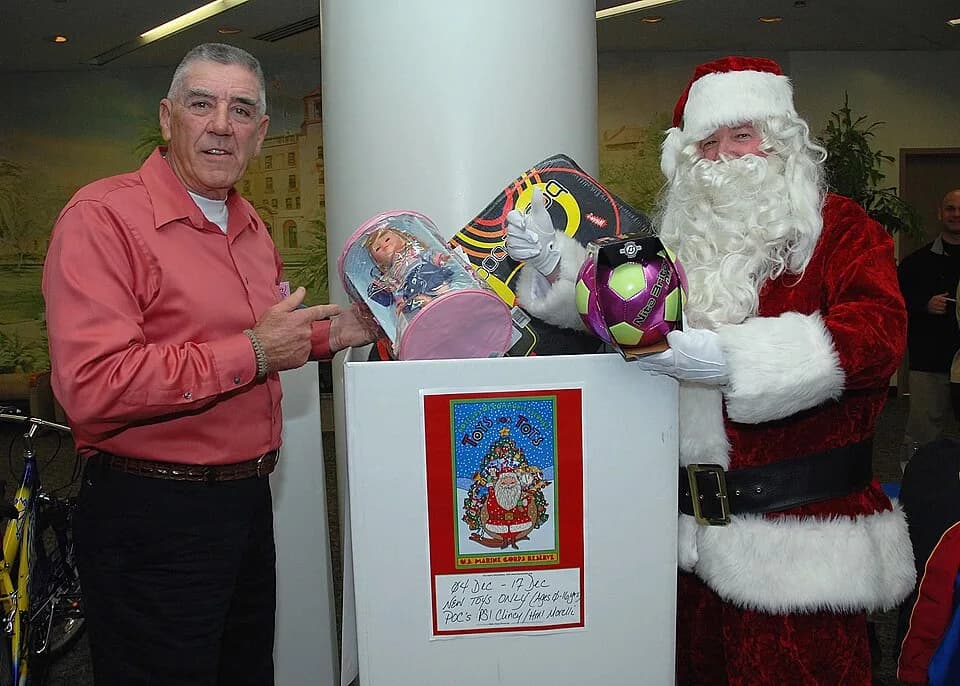 R. Lee Ermey - Former U.S. Marine Corps drill instructor turned Golden Globe-nominated actor R. Lee Ermey joins Santa Claus to put toys into the "Toys for Tots" donation box at Naval Medical Center Sa