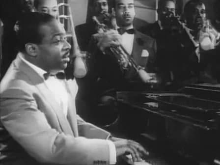 Count Basie - Cropped screenshot of Count Basie from the film Stage Door Canteen.