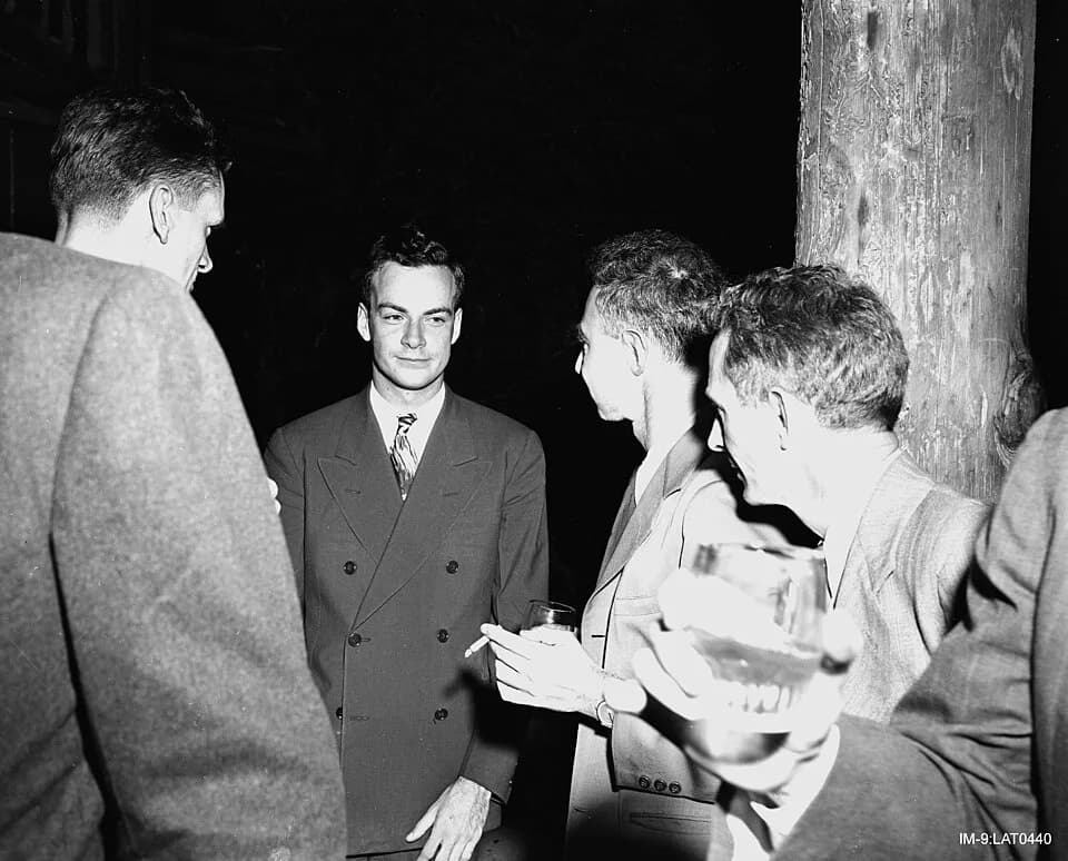 Richard Feynman - Richard Feynman (center) and Robert Oppenheimer (to viewer's right of Feynman) at Los Alamos National Laboratory during the Manhattan Project.