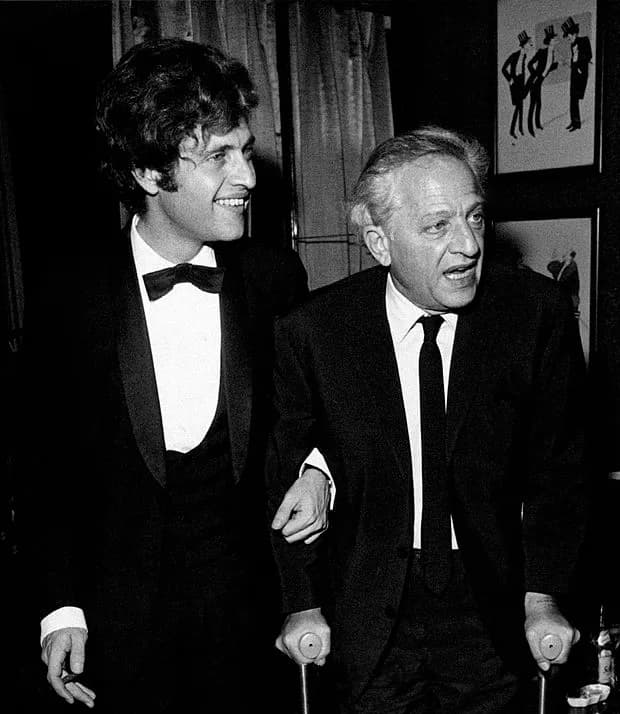 Joe Dassin - American-born French singer Joe Dassin helping his father, American director Jules Dassin walking on crutches. Paris, 1970.