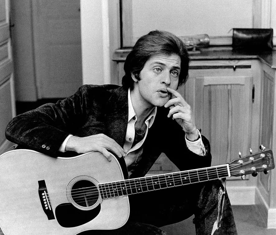 Joe Dassin - Portrait of American-born French singer Joe Dassin with a guitar in his hands. Paris, 1960s.
