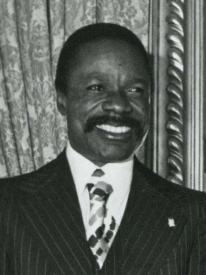 Omar Bongo - Black and white photograph print of Carl Albert, President Albert Barnard Bongo of the Gabonese Republic, and others posing behind Albert's desk, August 3, 1973