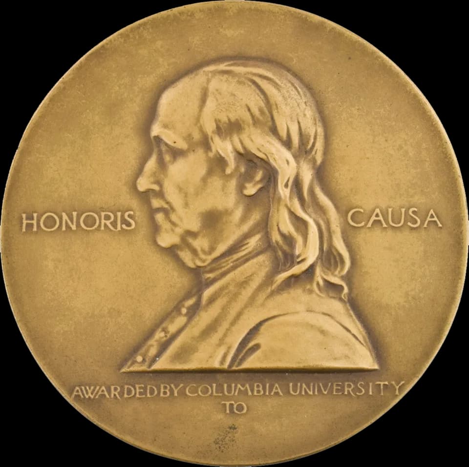 Erik Erikson - Obverse (front) side of the gold Pulitzer Prize for Public Service medal, which also serves as a symbol of the Pulitzer Prizes in general. It features a profile portrait of Benjamin Fra
