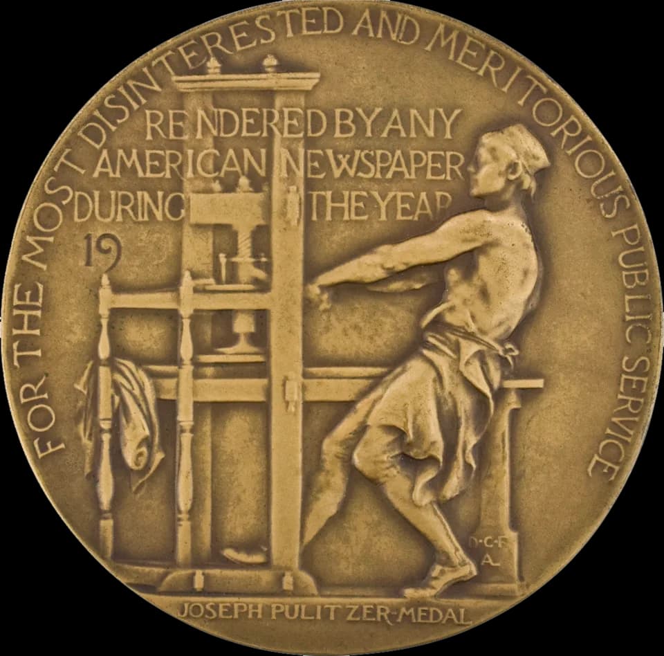 Erik Erikson - Reverse side of the gold Pulitzer Prize for Public Service medal, which also serves as a symbol of the Pulitzer Prizes in general. It features an image of a bare-chested man using a han
