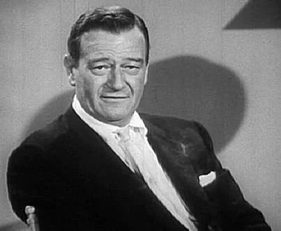 John Wayne - Screenshot  of John Wayne from The Challenge of Ideas (1961) (Part 1), a PD movie.