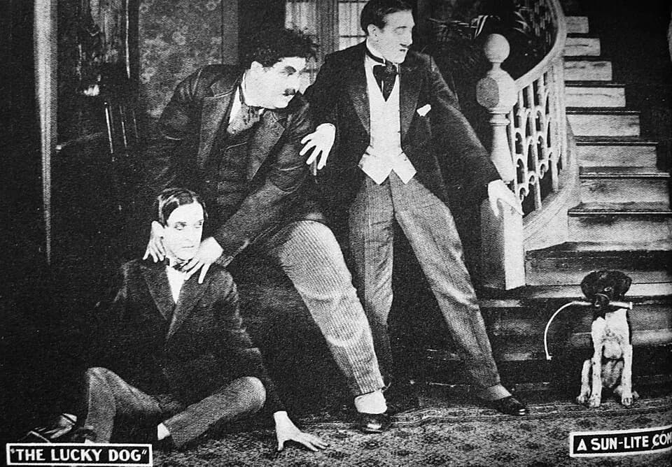 Oliver Hardy - Lobby Card c. 1921 featuring the first appearance on film by Laurel and Hardy, in The Lucky Dog produced in 1919 and released in 1921. Stan Laurel is seated with a mustachioed Oliver Ha